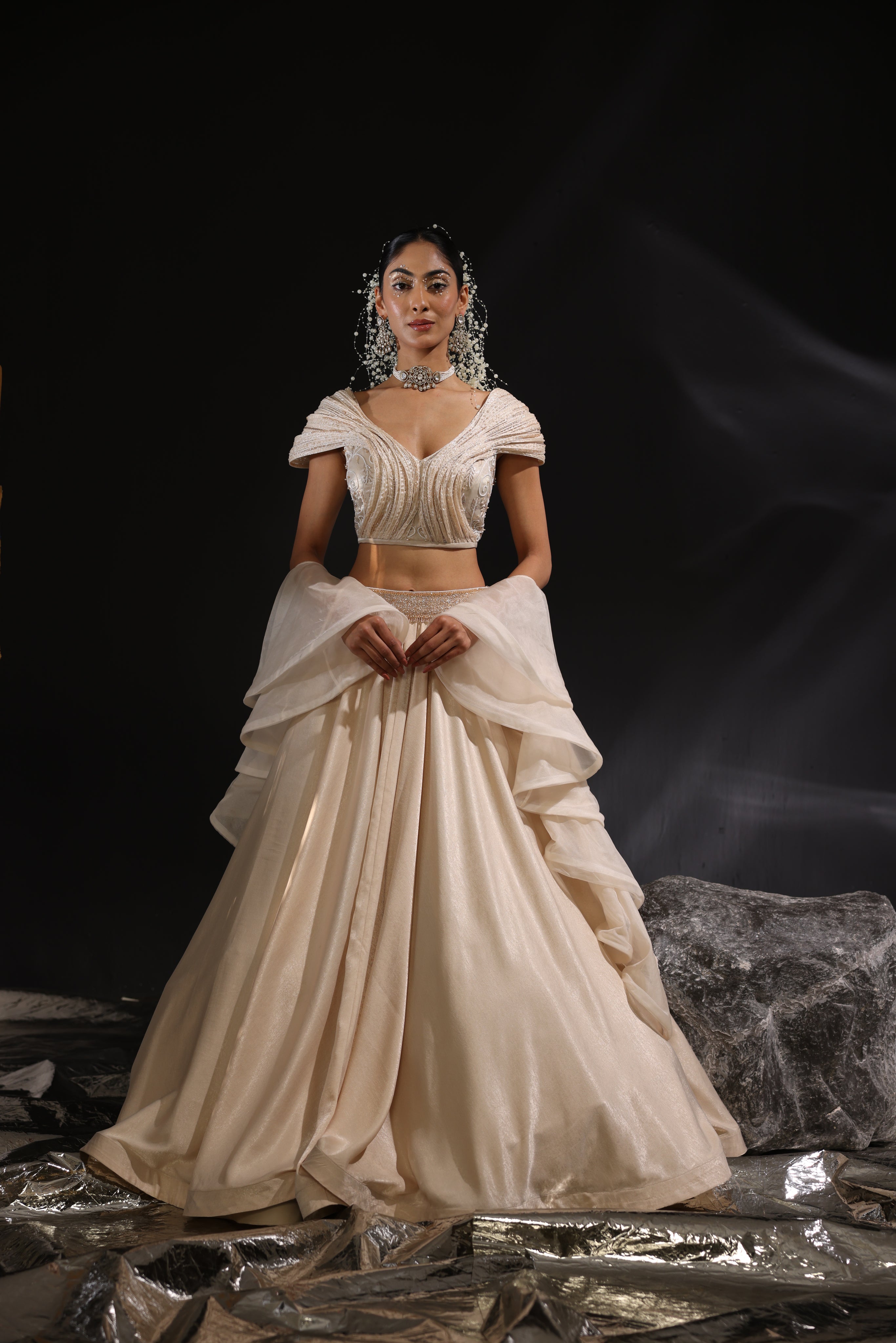 Sculpted blouse paired with ruffle dupatta & lehenga