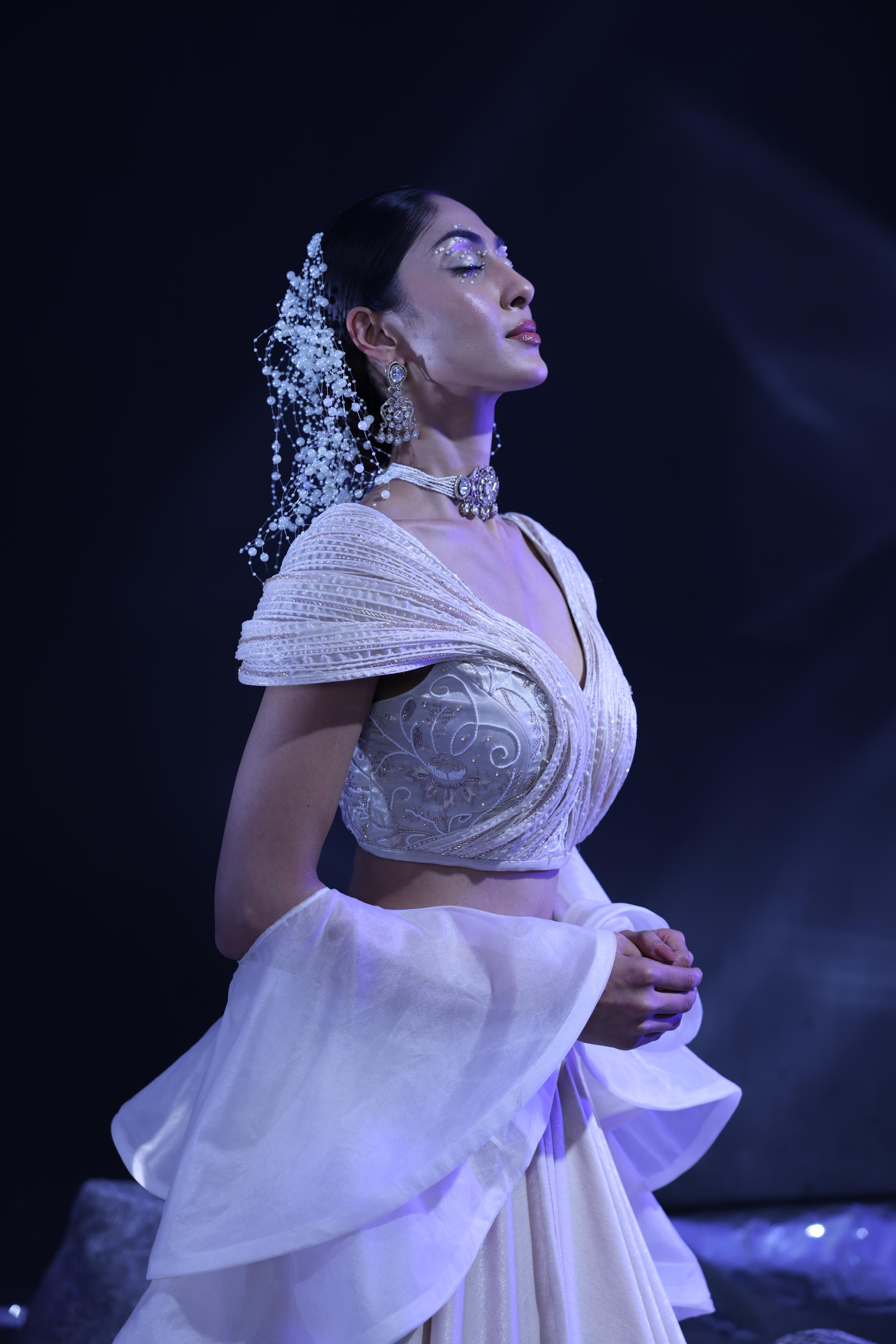 Sculpted blouse paired with ruffle dupatta & lehenga
